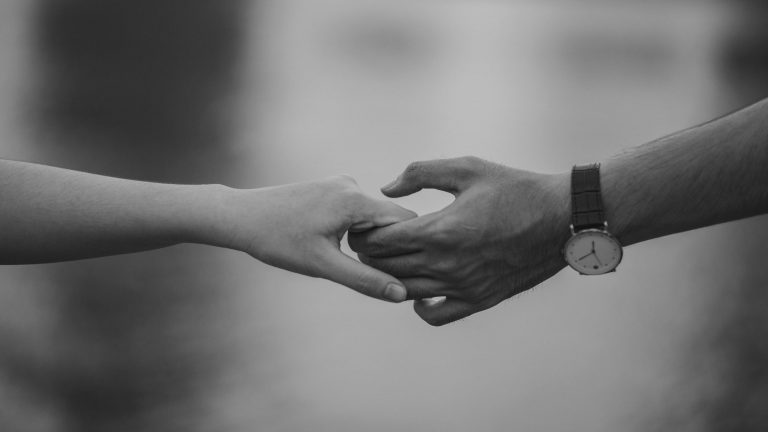 Black and White Photo a 2 people holding hands